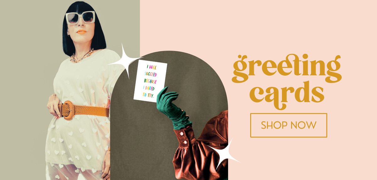 Promotional graphic for greeting cards featuring a woman in a white dress and sunglasses holding a card, alongside a hand in a green glove holding a card, with the text 'greeting cards' and 'SHOP NOW' on a peach background.