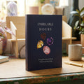 Book titled 'Unbillable Hours' with gemstone illustrations on a desk.
